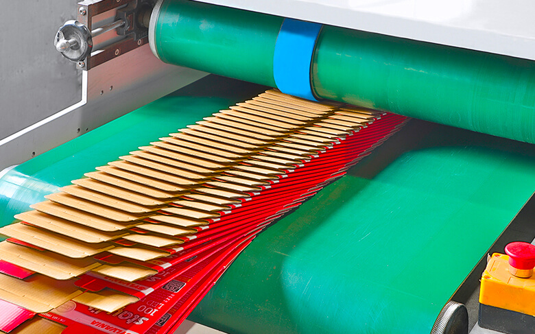 a batch of printed boxes coming out from an automatic gluing machine